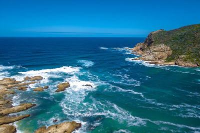 Scenic view of sea against clear blue sky