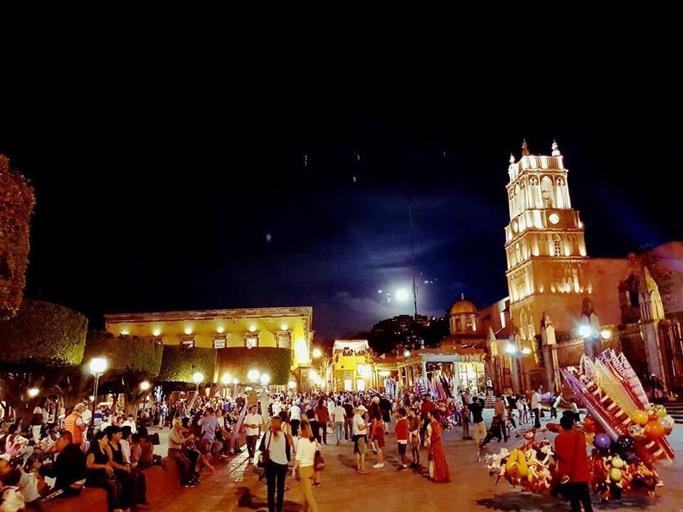 night, illuminated, travel, travel destinations, large group of people, architecture, history, city, men, building exterior, people, crowd, women, built structure, sky, outdoors, adult, adults only, astronomical clock