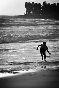 Woman jumping on beach