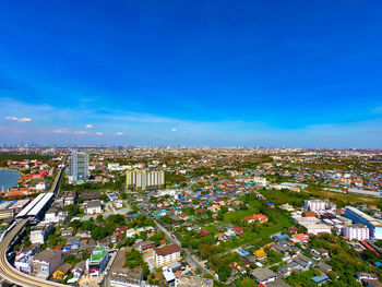 High angle view of buildings against blue sky