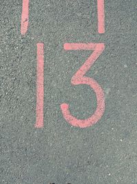 High angle view of number 13 sign on road