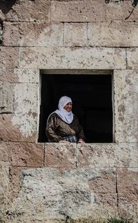 Woman looking through window