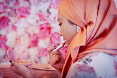 Woman holding pink flower