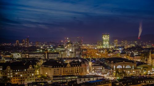 High angle view of city lit up at night