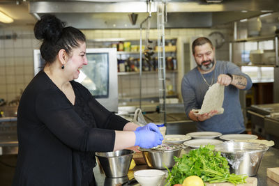 Man and woman in restaurant kitchen