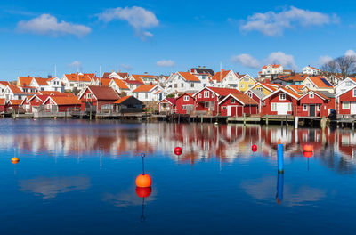 Reflection of buildings in lake against sky