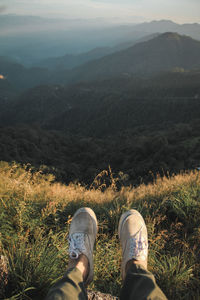 Low section of person standing on mountain