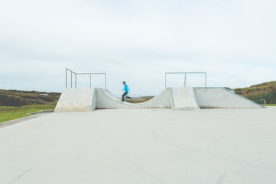 Blurred image of man skateboarding at park