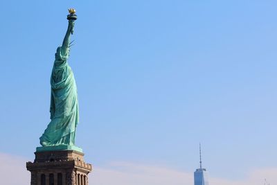 Low angle view of statue against blue sky