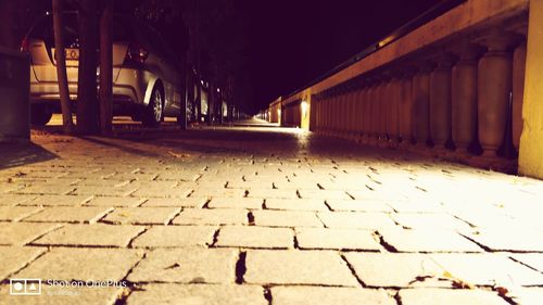 Illuminated cobblestone at night