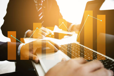 Double exposure of graph and business colleagues working in office