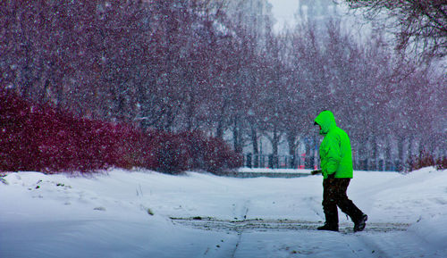 Full length of person walking on snow covered landscape