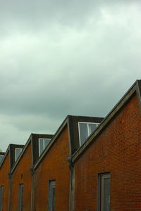 High section of building against cloudy sky