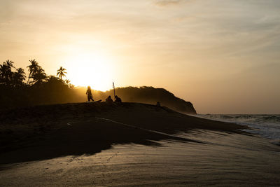 Scenic view of beach against sky during sunset