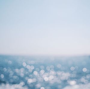 Defocused image of sea against clear sky