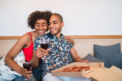 Happy young couple sitting on table