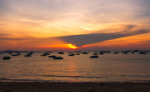 Scenic view of sea against romantic sky at sunset