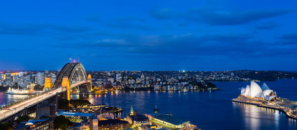 Illuminated city against sky at night