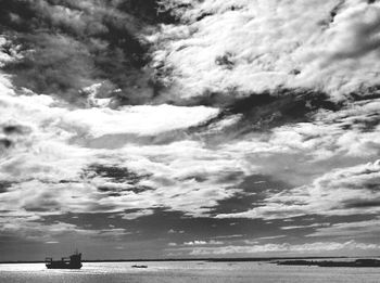 Scenic view of sea against cloudy sky