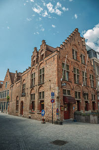 Street amidst buildings against sky in city