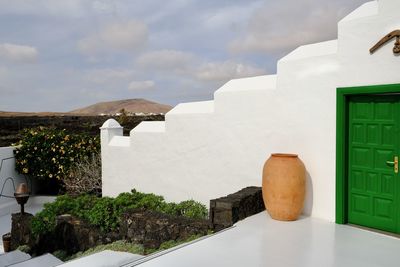 White building against cloudy sky