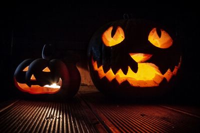 Close-up of illuminated pumpkin against black background