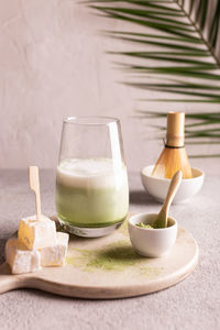 Green tea matcha latte on a white stone board