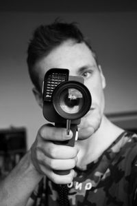Close-up of man looking through object