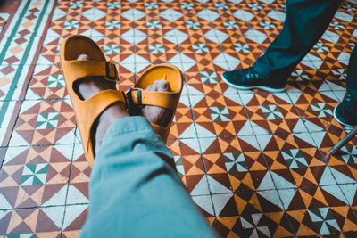 Low section of people standing on tiled floor