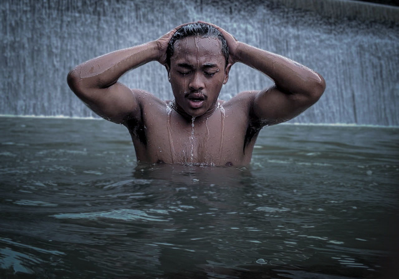 swimming, water, one person, wet, adult, portrait, men, nature, front view, lifestyles, emotion, muscular build, outdoors, young adult, splashing, eyes closed, waist up, sports, headshot, day, drop, strength, human face