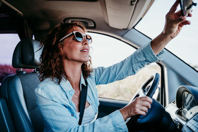 Mid adult man sitting in car