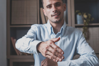Portrait of man holding hands