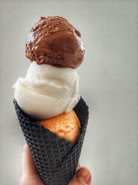 Close-up of hand holding ice cream cone