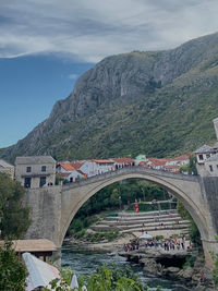 Bridge over mountain against sky