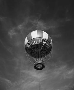 Low angle view of hot air balloon against cloudy sky