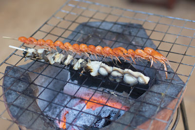 High angle view of meat on barbecue grill