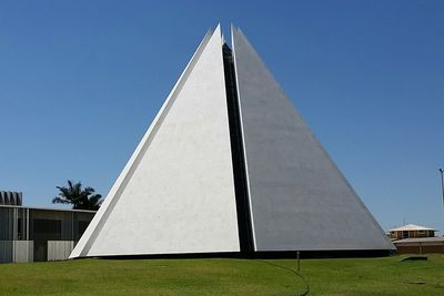 Low angle view of modern building against clear blue sky