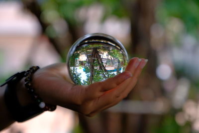 Close-up of hand holding crystal ball