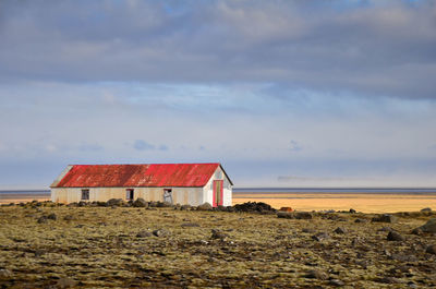 House on field against sky