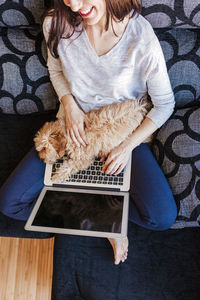 Midsection of woman sitting at home