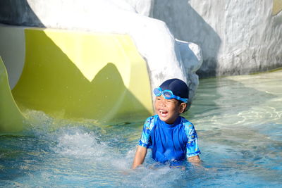 Cheerful boy enjoying in swimming pool