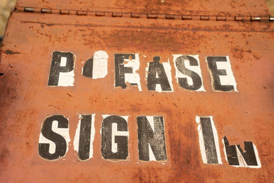 Close-up of text on old brick wall