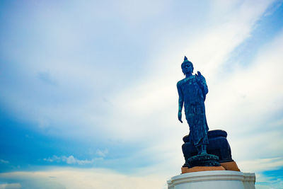 Low angle view of statue against blue sky