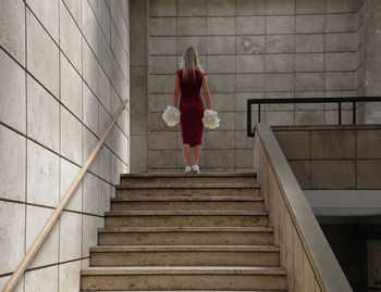 Rear view of woman on staircase