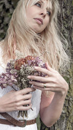 Beautiful young woman with flowers in hair