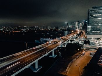 High angle view of illuminated city street and buildings at night