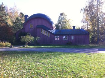 House on field against clear sky