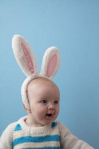 Portrait of cute baby girl with mouth open