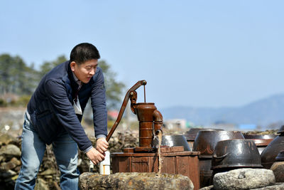 Side view of man working at construction site