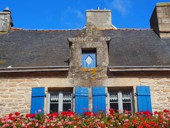 The house with blue shutters.